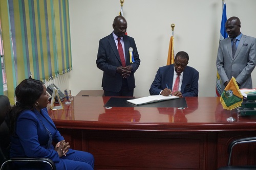 The area MP signing the visitors book in the VCs ffice